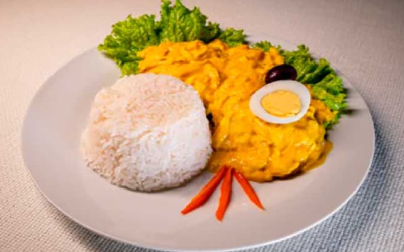 Ají de gallina with rice, egg and olive, a creole typical dish of the Peruvian coast