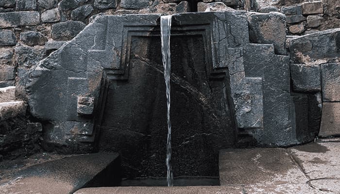 Inca stone fountain with water channel in Ollantaytambo, Sacred Valley