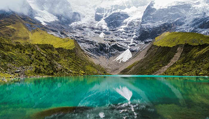 Humantay Lake with turquoise water and snow-capped mountain in the background