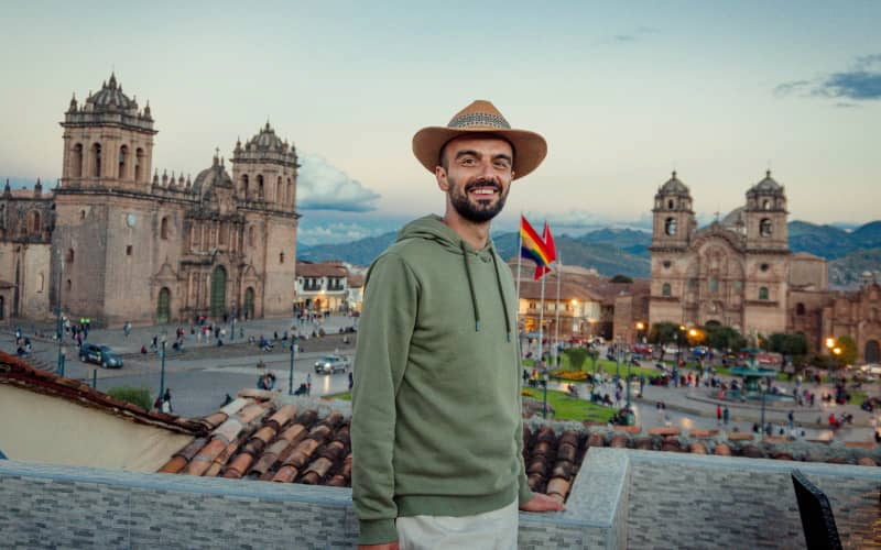 Traveler at Cusco's Main Square at sunset, one of the destinations when traveling to Peru