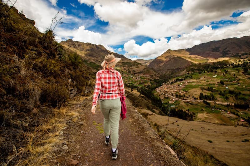 Hiker on a trail with a panoramic view of the Sacred Valley of the Incas in Cusco