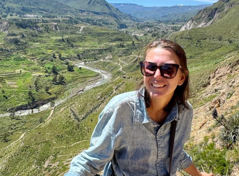 Tourist at Colca Canyon with views of the agricultural terraces and river below