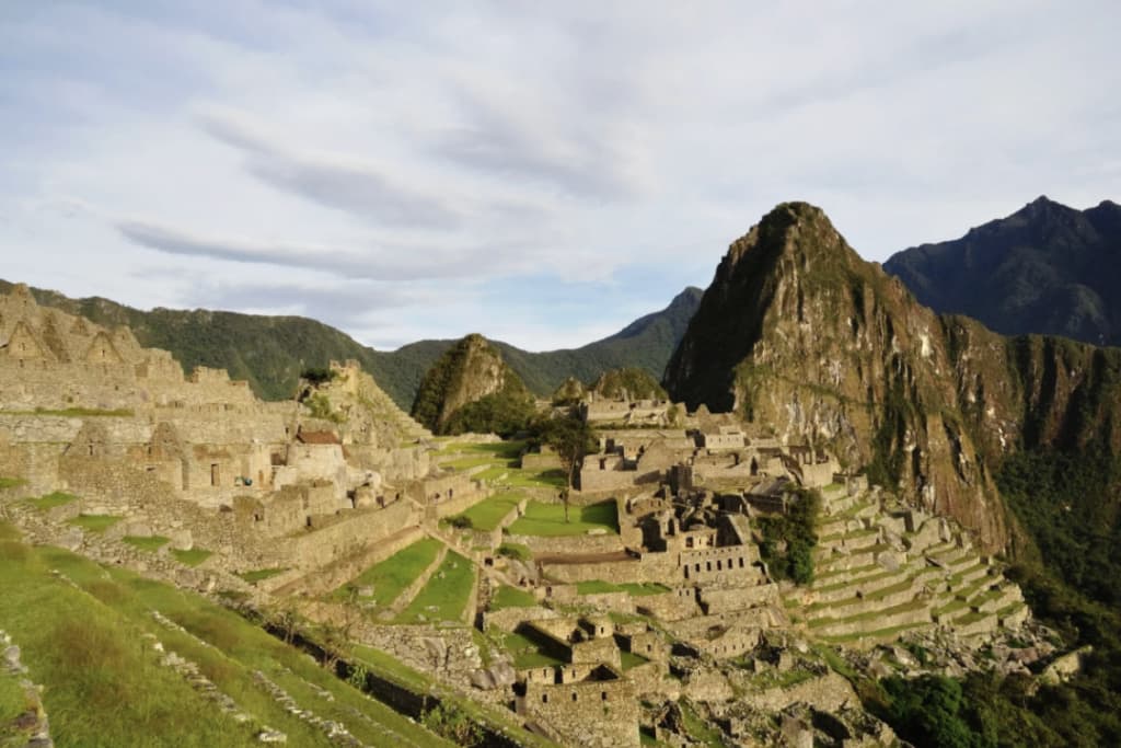 Machu Picchu citadel with its terraces and Huayna Picchu at sunrise