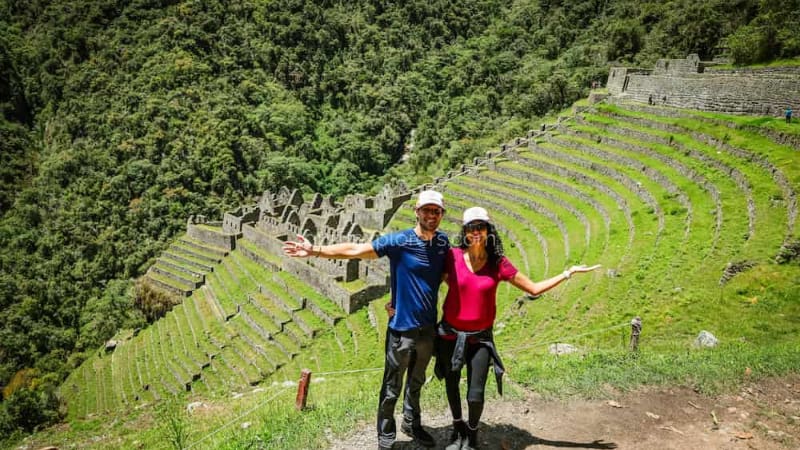 Couple of travelers at the Wiñay Wayna archaeological site during Inca Trail trekking